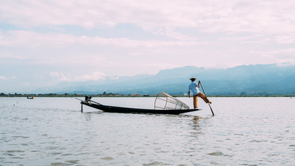 Fisherman on Inle Lake, Myanmar with traditional boat