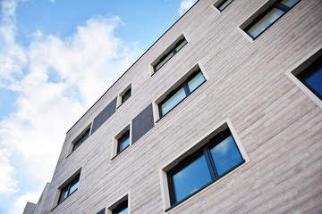 Modern apartment buildings on a sunny day with a blue sky. Facade of a modern apartment building.