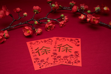 Chinese New Year decorations with red background with assorted festival decorations. Chinese characters means abundant of wealth, prosperity and luck. Flat lay or top view. 