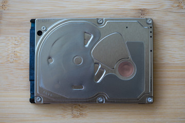 Top view of a hard disk drive on a wooden table