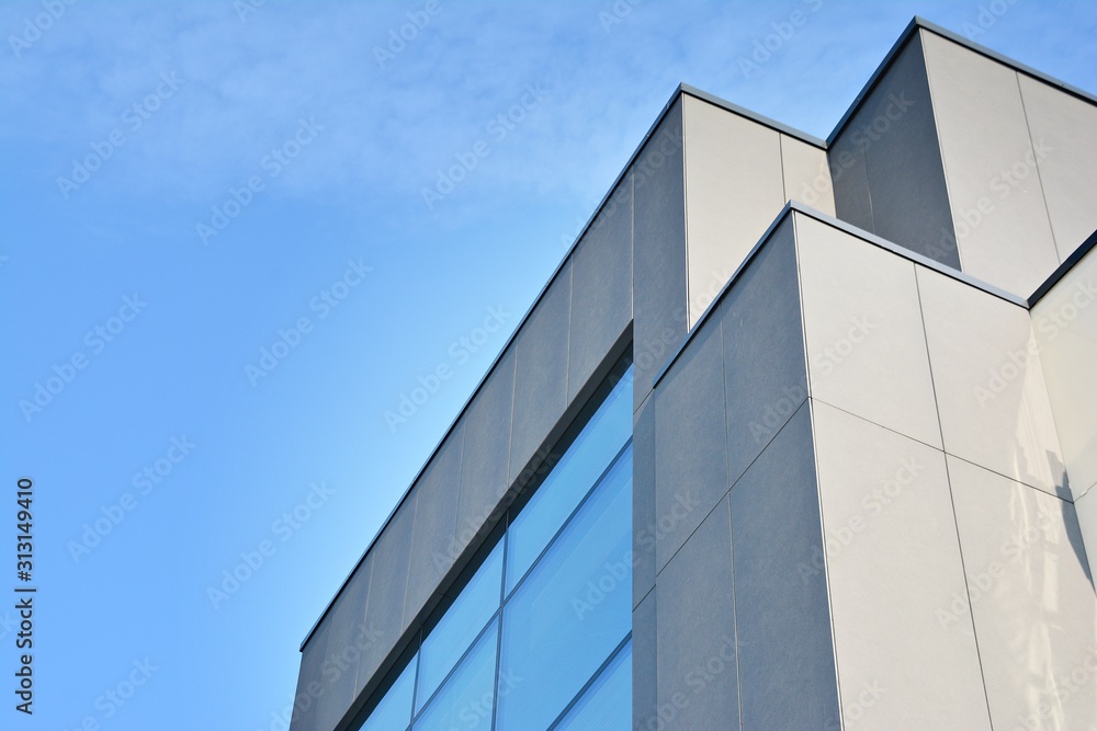 Wall mural abstract image of looking up at modern glass and concrete building. architectural exterior detail of