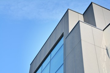 Abstract image of looking up at modern glass and concrete building. Architectural exterior detail of office building. 