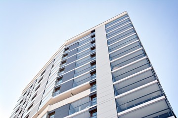Obraz premium Modern apartment buildings on a sunny day with a blue sky. Facade of a modern apartment building.