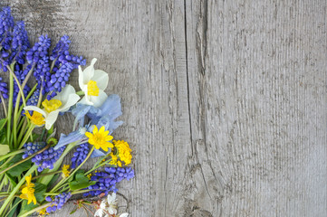 bouquet of spring flowers on wooden background with copy space for text