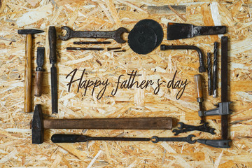 Concept for the Happy Father's Day holiday. Old vintage carpenter's construction tools on a wooden surface.