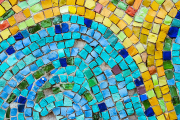 Colorful old stone mosaic on the wall, bright tiles, floral theme © Torkhov