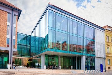 Modern glass library building at the center of Celje old town in Slovenia. Architecture in...