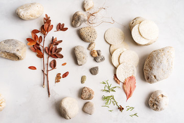Natural background of minerals, sea, shell, stones, luff, loofah on light concrete surface with...