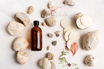Fototapeta na wymiar Flat lay composition with two brown glass bottles over Natural background of real tree bark, moss on light stone surface with copy space for mockup of body care organic cosmetics.