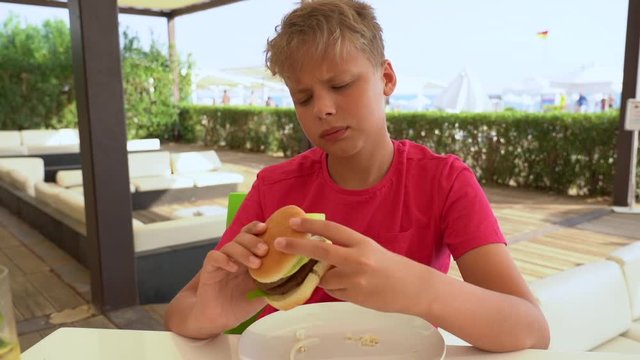 Cute White Kid Does Not Want To Eat Burger. 