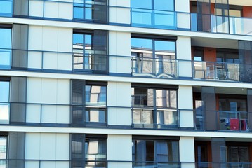 Obraz premium Modern apartment buildings on a sunny day with a blue sky. Facade of a modern apartment building.
