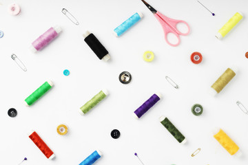 White background with different tools for sewing and tailoring
