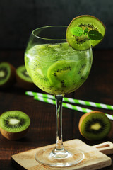 A glass with kiwi cocktail	