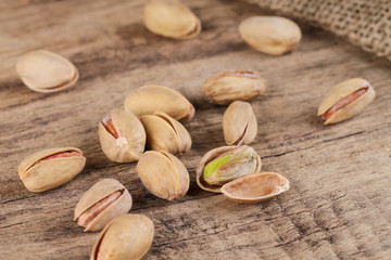 Group of pistachios on a wooden table. Healthy food.