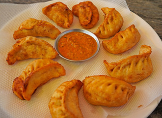 Fried momo and chili sauce. Served on the plate in the restaurant in Kathmandu, Nepal 