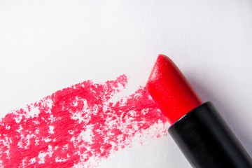 Tube of lipstick and smear on white, top view. Lipstick and smear tube isolated on white, top view. Concept. Close-up.