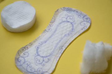 Floral clean sanitary pad on yellow background, cotton buds and pads for make-up, hygiene concept, women products, isolated