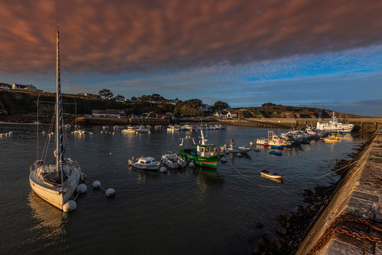 Saint-Gildas-Houat Port in Houat Island as seen in early morning from the pier, the village building in the background .