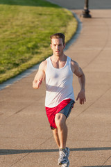 Caucasian man jogging outdoors in the early morning - 313156429
