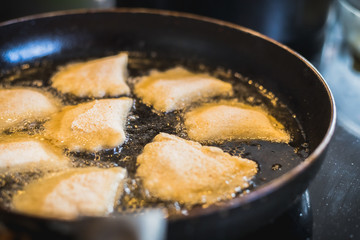 fried Portuguese or Brazilian rissoles in a frying pan