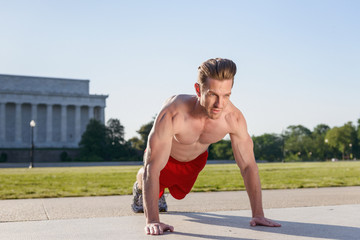 Fit Caucasian man doing pushups during and intense outdoor morning work out on the National Mall in Washington DC - 313156800