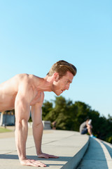 Fit Caucasian man doing pushups during and intense outdoor morning work out on the National Mall in Washington DC - 313157030