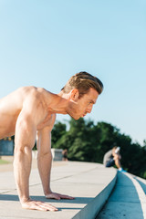 Fit Caucasian man doing pushups during and intense outdoor morning work out on the National Mall in Washington DC - 313157033