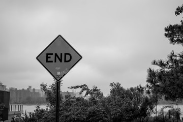 end of the road warning sign in black and white
