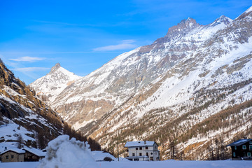 alpine panorama, snowy mountains with blue sky