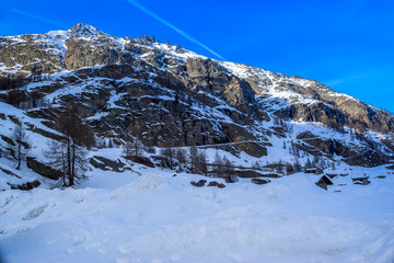 alpine panorama, snowy mountains with blue sky