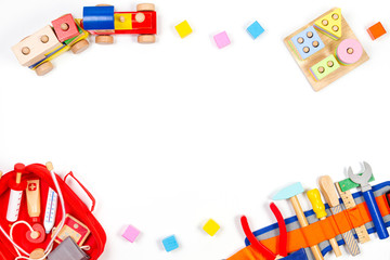 Baby kids toys background. Wooden educational toys, train, rainbow, airplane, blocks, construction tools and set of toy medical devices on white background