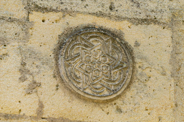 Close-up of architectural decoration on facade of fountain. Armenian fountain (Karaite fountain) was built at foot of Mount Mithridates in 16th century in Feodosia. Crimea, Russia - September, 2019