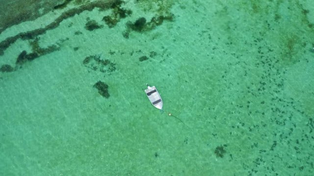 Aerial drone flight over anchored boat, Bali, Indonesia, 4k