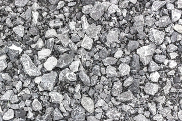 Stone background. Gray gravel. Granite texture. The rocky road. Fine pebbles. Construction material. The texture of the stones. Wallpaper with fine gravel.