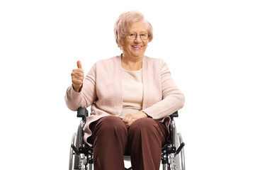 Disabled wlderly woman in a wheelchair and smiling at the camera with thumbs up