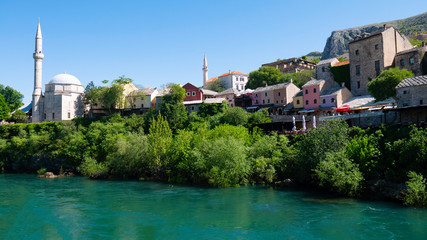 Fototapeta na wymiar View from the Neretva River to the old town of Mostar, Bosnia and Herzegovina, April 2019.