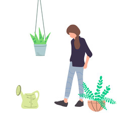 Girl watering flowers in a pot. Creating favorable conditions in a greenhouse