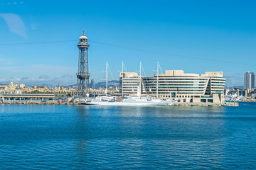 Cruise Port with a tower Torre Jaume I, World Trade Center Barcelona, Hotel Eurostars Grand Marina and a yacht Wind Star in Barcelona - obrazy, fototapety, plakaty