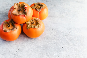 Ripe Fuyu Persimmon Isolated on Light Background, Closeup with Copy Space