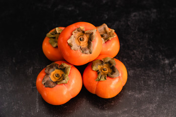Ripe Fuyu Persimmon Isolated on Light Background, Closeup Top View