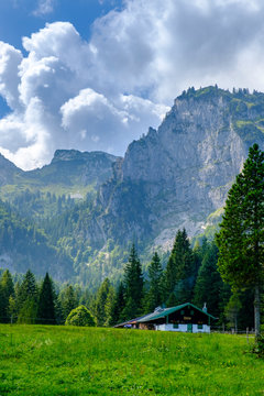 Scenic view of secluded Hintere Langentalalm cafe with Benediktenwand ridge in background