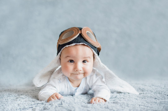 Cute Smiling Baby In Cap Of Pilot. Aviation Day.