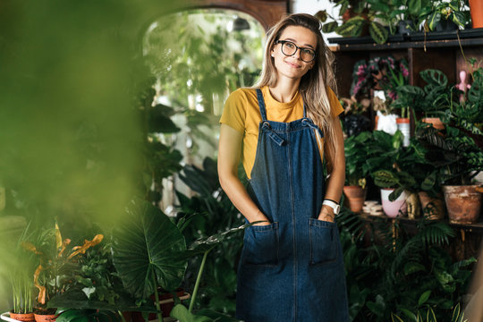 Portrait of a young woman in a small gardening shop