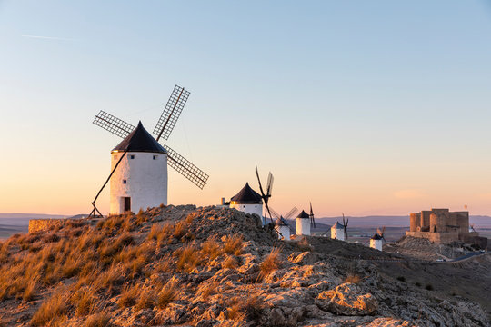 Row of old windmills standing on top of hill