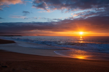 Naklejka na ściany i meble Sunset at the beach with winter sky
