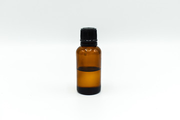 Glass bottle of tea tree oil isolated on white background