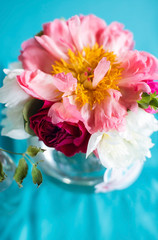 Flowers as a decoration at a wedding. Stunningly beautiful pink peonies in a glass vase.
