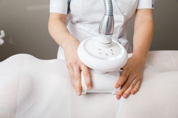 Beautiful woman getting beauty therapy against cellulite with LPG machine on her butt. LPG massage...