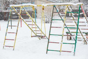 The playground is covered with snow. a