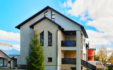 Apartment in residential building exterior. Housing structure at blue modern house of Europe. Rental home in city district on summer. Wall and glass high architecture for business property investment.